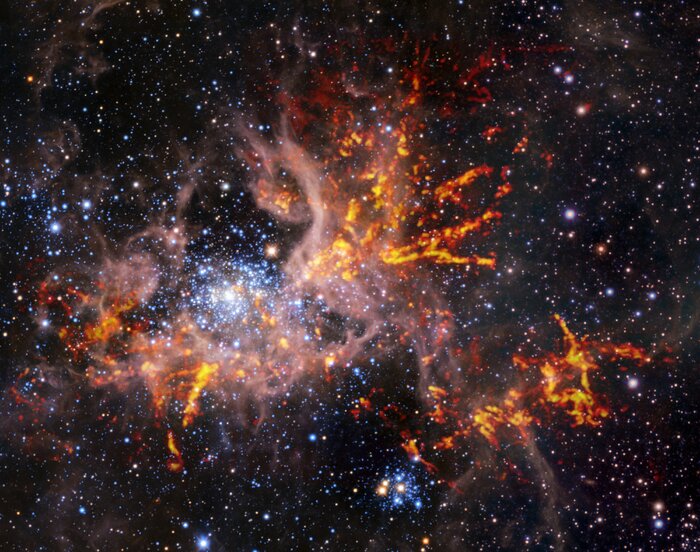 A tarantella kozmikus hálójában: heves csillagkeletkezés egy Tejútrendszeren kívüli anyagfelhőben